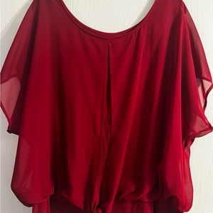 Very comfortable and beautiful blouse!! Color is a deep red.. sixe3x